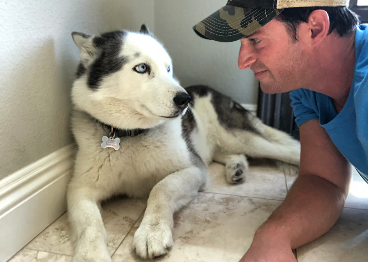 Justin, Cannanine's founder, nose to nose with his senior husky Splash